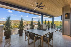 View of patio / terrace with ceiling fan and a mountain view