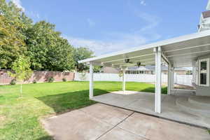 View of patio with ceiling fans