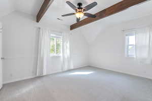 Primary room featuring vaulted ceiling with beams and ceiling fan