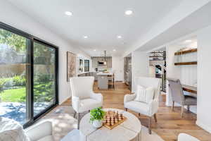 Family room with fireplace and large glass sliding doors that open to the private backyard.