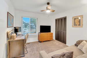 Bedroom with  light carpet and ceiling fan