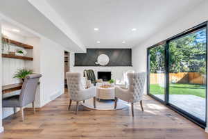 Family room with fireplace and large glass sliding doors that open to the private backyard.