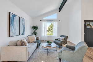 Living room with lofted ceiling and full of natural light.