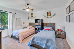 Carpeted bedroom with ceiling fan