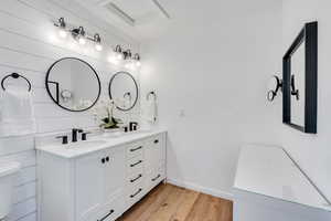 Primary bedroom suite featuring double vanities.