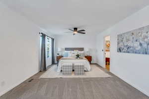 Large primary bedroom suite with private deck, spacious bathroom, and walk in closet.