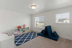 Recreation room featuring a textured ceiling and carpet