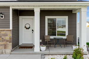 Doorway to property with covered porch