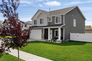 View of front facade with a front lawn and a garage