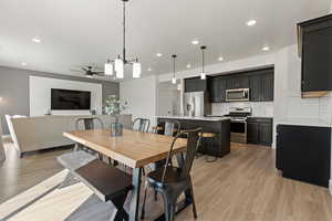 Dining space featuring light hardwood / wood-style floors, ceiling fan, and sink