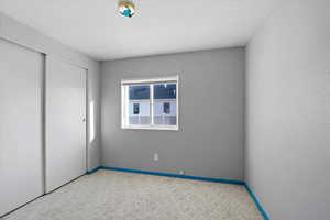 Unfurnished bedroom featuring carpet floors and a closet