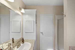 Bathroom with vanity and an enclosed shower