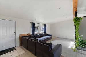 Carpeted living room featuring a textured ceiling