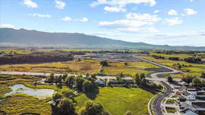 Aerial view featuring a water and mountain view