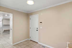 Tiled foyer with ornamental molding