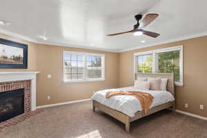 Bedroom with ceiling fan, carpet floors, and multiple windows