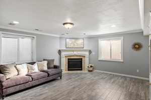 Recreation room with fireplace featuring  wood-style flooring,