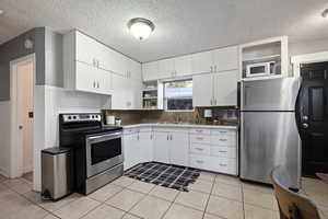 All appliances are included: fridge, microwave, range and portable dishwasher (stored in the garage)