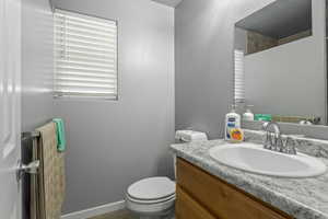 Bathroom featuring vanity and toilet