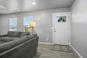 Entryway featuring a textured ceiling and wood-type flooring