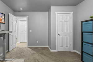 Unfurnished bedroom featuring light carpet