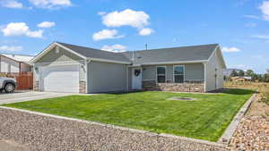 View of front of property with a front lawn and a garage