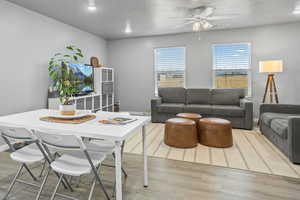 Living room featuring ceiling fan and hardwood / wood-style floors