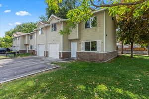 View of front of home with a garage and a front yard