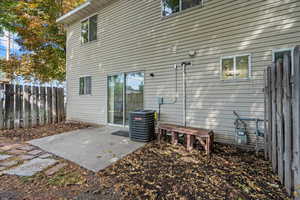 Rear view of house with a patio and cooling unit