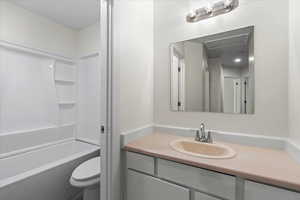 Full bathroom featuring shower / bathtub combination, vanity, and toilet