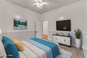 Bedroom featuring light carpet and ceiling fan