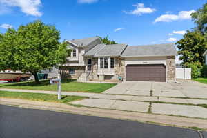 View of front of home featuring a garage and a front lawn