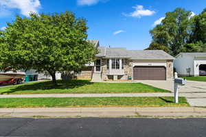 View of front of house featuring a garage and a front lawn