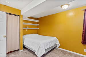 Bedroom with carpet floors and a textured ceiling