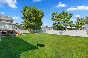 View of yard with a wooden deck