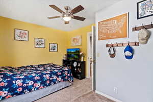 Carpeted bedroom with ceiling fan