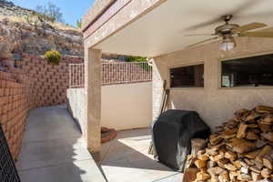 View of patio with ceiling fan and grilling area