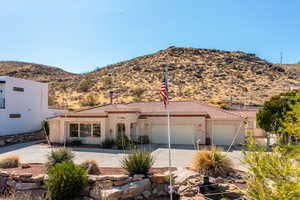 View of front facade featuring a mountain view and a garage