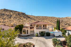 Mediterranean / spanish house with a mountain view, a balcony, and a patio area