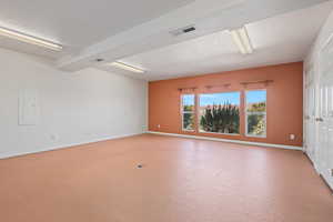 Spare room with a textured ceiling and electric panel