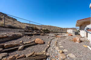 View of yard featuring a storage shed and a mountain view