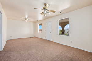 Carpeted spare room with a textured ceiling and ceiling fan