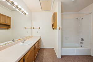 Bathroom featuring vanity and tiled shower / bath