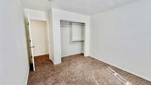 Unfurnished bedroom with carpet floors and a closet