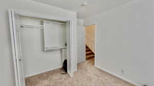 Carpeted bedroom featuring a closet