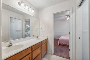 Bathroom with ceiling fan and vanity