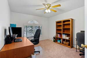 Carpeted office space with ceiling fan