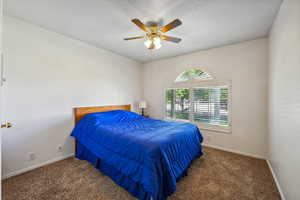 Carpeted bedroom with ceiling fan