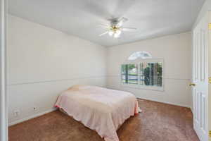 Bedroom with ceiling fan and carpet flooring