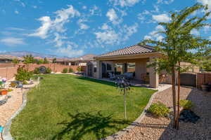 Lovely back yard  with covered patio and fully fenced with 2 side gates.